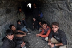 Afghan migrants hide from security forces in a tunnel under train tracks after crossing illegally into Turkey from Iran, near Tatvan in Bitlis province, Turkey, Aug. 23, 2021.