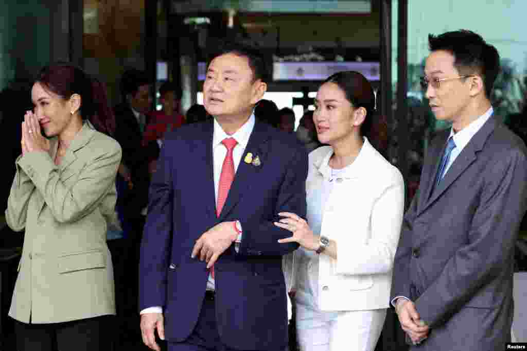 Exiled former Thai Prime Minister Thaksin Shinawatra walks with his son Panthongtae Shinawatra and daughters Paetongtarn Shinawatra and Pintongtha Kunakornwong at Don Mueang airport in Bangkok, Thailand.