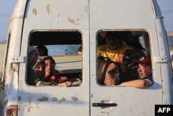 Raseljeni Palestinci sede uz svoje stvari u kombiju vozeći se ka kampu al-Burej u centralnom delu Poasa Gaze, 2. juna 2024.