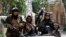FILE - Taliban fighters display their flag on patrol in Kabul, Afghanistan, Aug. 19, 2021.