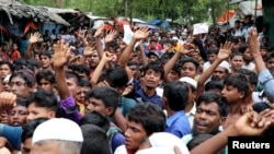 FILE - Rohingya refugees shout slogans as they take part in a protest at the Kutupalong refugee camp to mark the one-year anniversary of their exodus, in Cox's Bazar, Bangladesh, Aug. 25, 2018.