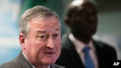 Philadelphia Mayor Jim Kenney, left, accompanied by City Solicitor Sozi Pedro Tulante, speaks during a news conference in Philadelphia, Nov. 15, 2017. A federal judge Wednesday blocked the U.S. government from withholding a major grant that pays for public safety equipment because Philadelphia is a "sanctuary city."