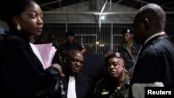 FILE - Congolese army Colonel Mike Mikombe sits with his lawyer after being sentenced to death for murder and other crimes for the killing of 56 protesters, pictured in a military auditorium in Goma, October 2, 2023.