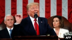 FILE - President Donald Trump steps to the podium to begin his State of the Union address to a joint session of Congress on Capitol Hill in Washington, Jan. 30, 2018.