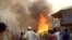Rohingya refugees watch smoke rising following a fire at the Rohingya refugee camp in Balukhali, southern Bangladesh, March 22, 2021. 