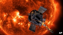 FILE - This image made available by NASA shows an artist's rendering of the Parker Solar Probe approaching the Sun. It's designed to take solar punishment like never before, thanks to its revolutionary heat shield that's capable of withstanding 1,370 degrees Celsius.