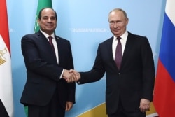 FILE - Russian President Vladimir Putin, right, and Egypt's President Abdel Fattah el-Sissi pose for a photo prior to talks in the Black Sea resort of Sochi, Russia, Oct. 23, 2019.