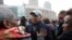 Former Mass. Gov. Deval Patrick, center, greets people in a crowd, April 2, 2018, before a remembrance on City Hall Plaza, in Boston.