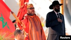 King Mohammed VI of Morocco, left, and South Sudan's President Salva Kiir stand for the national anthem after he arrived at the Juba airport in South Sudan's capital Juba, Feb. 1, 2017. 