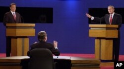 Moderator Jim Lehrer tells Republican presidential candidate Texas Gov. George W. Bush, right, that the candidates made the rules as Democratic presidential candidate Vice President Al Gore listens at the first presidential debate Tuesday, Oct. 3, 2000, a