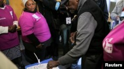 Archbishop Emeritus Desmond Tutu casts his vote during local government elections in Milnerton, Cape Town, South Africa, Aug. 3, 2016.