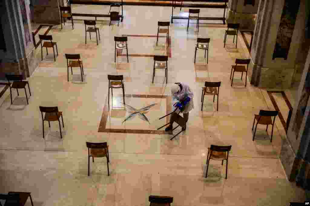 A woman cleans SS. Quirico and Giulitta Church in Giussano, Italy. Churches in Italy are preparing to reopen to the public for masses after Italy partially lifted restrictions following a two-month lockdown due to COVID-19.