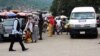 Abuja natives have been displaced, and many engage in street hawking, selling wares to drivers, to make a living. (C. Oduah/VOA)