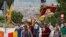 Buddhist monk Thubten Wangchen (3rd R) and participants walk with Tibetan flags and images of Mahatma Gandhi during their march for "peace and non-violence" from Plaza d'Espanya [Spain Circus] to the Montjuich castle in Barcelona October 2, 2010.