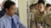 A Cambodian court spokesman Huy Vannak, left, delivers court documents at the court entrance of the U.N.-backed war crimes tribunal in Phnom Penh, Cambodia, Tuesday, Nov. 22, 2011. Pol Pot's close confederates cannot solely blame their late leader for th