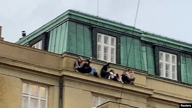 Bir öğrenci grubunun pencerelerden tırmanarak binanın yaklaşık beş kat yukarısındaki bir çıkıntıya saklandıkları görülüyor.