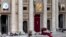 The tapestries, from left, of Laura di Santa Caterina da Siena Montoya of Colombia, Antonio Primaldo and his companions, also known as the Martyrs of Otranto, and Maria Guadalupe Garcia Zavala of Mexico hang from balconies in St. Peter's Square at the Vat
