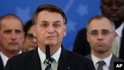 FILE - Brazil's President Jair Bolsonaro speaks during a press conference at the Planalto Presidential Palace in Brasilia, Brazil, April 24, 2020. 