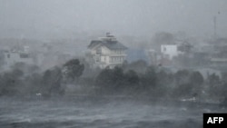 High winds whip water onto the shore of Phuong Luu Lake as Typhoon Yagi hits Hai Phong, Vietnam, on Sept. 7, 2024. Yagi uprooted thousands of trees and swept ships and boats out to sea as it made landfall, state media said.