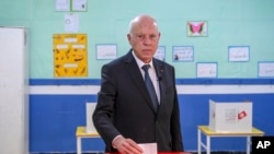 FILE - Tunisia's President Kais Saied casts his ballot during legislative elections in Tunis, Dec. 17, 2022. Saied replaced various ministers, including from the foreign and defense portfolios, the Tunisian presidency said in a statement posted on Facebook, Aug. 25, 2024.