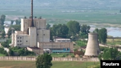 A North Korean nuclear plant is seen before demolishing a cooling tower (R) in Yongbyon, in this photo taken June 27, 2008 and released by Kyodo.