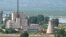 A North Korean nuclear plant is seen before demolishing a cooling tower (R) in Yongbyon, in this photo taken June 27, 2008 and released by Kyodo.