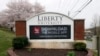 A sign marks the entrance to Liberty University, March 24 , 2020, in Lynchburg, Virginia. University President Jerry Falwell Jr. invited students back to campus this week, despite the fast-growing coronavirus pandemic.