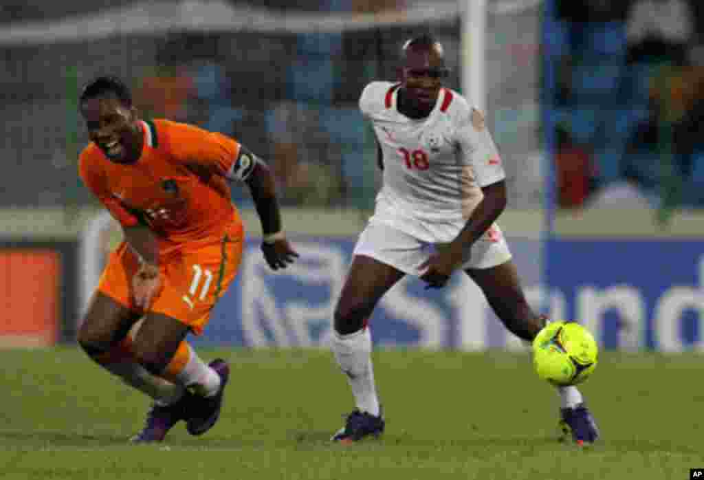 Drogba of Ivory Coast fights for the ball with Kabore of Burkina Faso during their African Nations Cup soccer match in Malabo