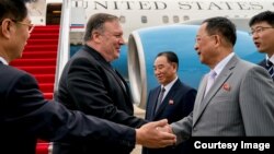 FILE - U.S. Secretary of State Mike Pompeo is greeted by North Korean Director of the United Front Department Kim Yong Chol, and North Korean Foreign Minister Ri Yong Ho, as he arrives at Sunan International Airport in Pyongyang, North Korea, July 6, 2018. Another meeting between Pompeo and his North Korean counterpart reportedly is being planned for next week.