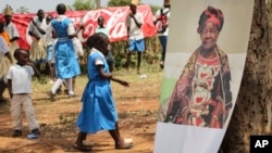 A poster of Sarah Obama, the step-grandmother of President Barack Obama, is displayed during a groundbreaking ceremony for her Mama Sarah Obama Foundation charitable organization, in her home town of Kogelo, near Kisumu, in Kenya Saturday, July 18, 2015.