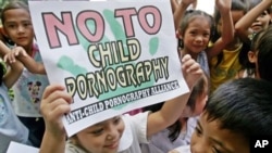 Filipino children show signs against child pornography during the start of a nationwide alliance to combat the growing problem in the Philippines. 