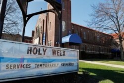 A sign highlighting Holy Week activities is displayed outside the Our Mother of Perpetual Help- St. James Parish, April 8, 2020, in Ferndale, Mich.