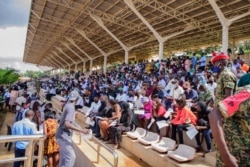 FILE - People wait in the stands to receive coronavirus vaccinations at the Kololo airstrip in Kampala, Uganda, May 31, 2021.