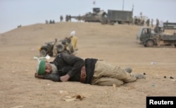 An elderly man with Shi'ite fighters sleeps in Tal Afar, Iraq, Nov. 16, 2016.