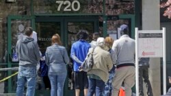 FILE - People line up outside the Utah Department of Workforce Services, April 13, 2020, in Salt Lake City.