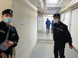 Police stand guard outside the Stand News office after six people were arrested "for conspiracy to publish seditious publication," according to Hong Kong's Police National Security Department, in Hong Kong, Dec. 29, 2021.
