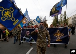 Members of the nationalist movement Svoboda (Freedom) go marching to mark the 74th anniversary of the Ukrainian Insurgent Army on Defenders Day in Kyiv, Ukraine, Oct. 14, 2016.