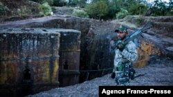 A militia fighter poses at Saint George's Church in Lalibela, Ethiopia, Dec. 7, 2021.