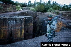 FILE—Amhara Fano militia fighter Eshete Zewudru poses at Saint George Church in Lalibela, on December 7, 2021.