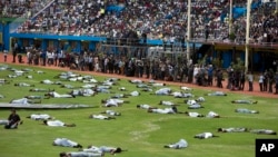 FILE - Performers re-enact events at a ceremony to mark the 20th anniversary of the Rwandan genocide, at Amahoro stadium in Kigali, Rwanda, April 7, 2014. 