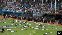 Performers re-enact events at a ceremony to mark the 20th anniversary of the Rwandan genocide, at Amahoro stadium in Kigali, Rwanda, April 7, 2014. 