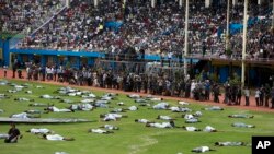 Performers re-enact events at a ceremony to mark the 20th anniversary of the Rwandan genocide, at Amahoro stadium in Kigali, Rwanda, April 7, 2014. 