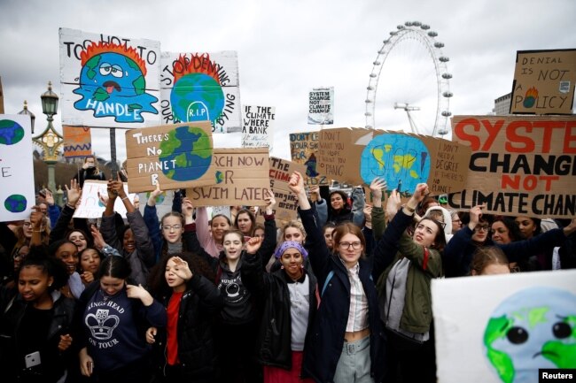 FILE - Demonstrators take part in a protest against climate change, organized by the YouthStrike4Climate movement, in London, March 15, 2019.