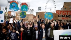 FILE - Demonstrators take part in a protest against climate change, organized by the YouthStrike4Climate movement, in London, March 15, 2019. 