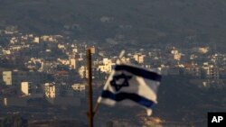 FILE - An Israeli flag flutters near the village of Majdal Shams in the Golan Heights.