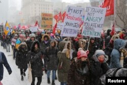 Participants walk to the Ontario provincial legislature during the Women's March in a -22 Celsius (8 Fahrenheit) wind chill snowstorm in Toronto, Ontario, Jan. 19, 2019.