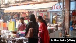Customers flock to markets selling gifts and sweets for the Hindu festival of Diwali. 