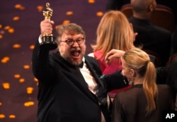 Guillermo del Toro, winner of the award for best director for "The Shape of Water" celebrates in the audience at the Oscars, March 4, 2018, at the Dolby Theatre in Los Angeles.