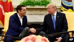 President Donald Trump, right, shakes hands with Greek Prime Minister Alexis Tsipras in the Oval Office of the White House in Washington, Oct. 17, 2017.