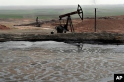 A pond of oil at an oil field controlled by a U.S-backed Kurdish group is seen in Rmeilan, Hassakeh province, Syria, March 27, 2018. The Syrian Kurds have been in control of some of the country's largest oil fields in Hassakeh province in the northeast starting in 2013.